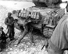 Korean War, 1951: A US soldier behind an M4A3 76(w) HVSS Sherman tank, with an M1918A2 M1918A2 BAR Korea.JPEG