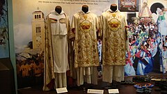 Capa pluvial (cope) and ornately embroidered dalmatic pairs (late 1800s, early 1900s, Our Lady of Manaoag museum, Philippines)
