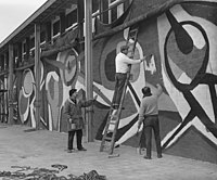 Karel Appel kwam uit Parijs en bracht april 1955 een muurschildering aan op het expositiegebouw E55, te Rotterdam