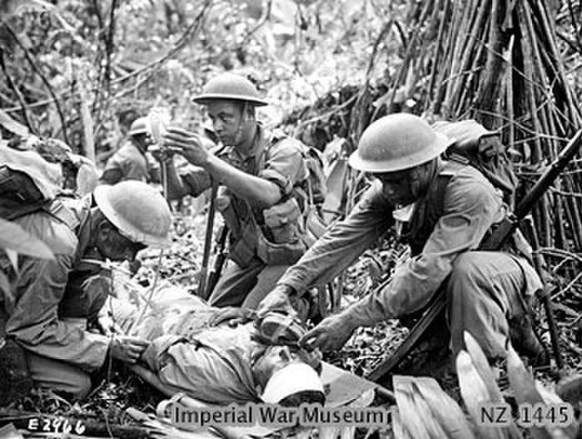 World War II. A Fijian medical orderly administers an emergency plasma transfusion during heavy fighting on Bougainville, c. 1944.