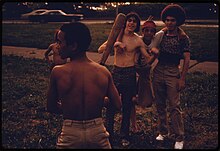 Puerto Rican boys playing softball in Brooklyn's Highland Park in 1974 PUERTO RICAN BOYS PLAYING SOFTBALL IN BROOKLYN'S HILAND PARK IN NEW YORK CITY. THE INNER CITY TODAY IS AN ABSOLUTE... - NARA - 555921.jpg