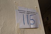 A sign indicating the polling station at the void deck of Block 115 Clementi Street 13 for the 2011 general election Polling station sign, Block 115 Clementi Street 13, Singapore - 20110507.jpg