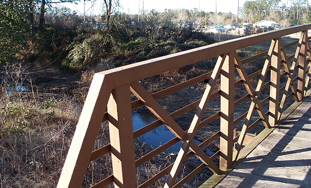 Footbridge across a tributary of Ponchatoula Creek leading to North Oak Street Park on the campus of Southeastern Louisiana University in Hammond, Tan
