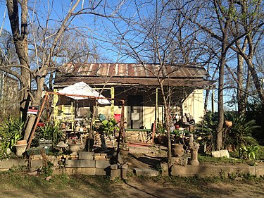 The dilapidated 79 Rainey Street in 2013, since renovated into Banger's Sausage House. Ramshackle on Rainey Street.jpg