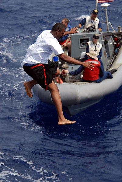 File:US Navy 080815-N-1635S-006 A Sailor jumps off of the flight deck of the Arleigh Burke-class guided-missile destroyer USS Howard (DDG 83) during a scheduled swim call.jpg