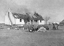 Boers watching their home being burnt by British forces during the Second Boer War VerskroeideAarde1.jpg