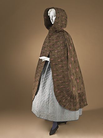 Woman's hooded cape with finely pleated trim, Provence, France, 1785-1820. Copperplate- and roller-printed plain weave cotton in a characteristic somber ramoneur (chimney sweep) print on a dark ground. Capes of similar fabrics based on floral-printed Indian calicoes were popular in Provence from about 1770 to 1830. Los Angeles County Museum of Art M.2007.211.669. Woman's hooded cape Provence 1785-1820.jpg