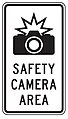 Road sign: “Symbol of camera with a flash” above “SAFETY” “CAMERA” “AREA”