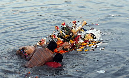 A Durga sculpture-idol in the river, post-immersion.