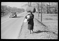 African-American woman carrying laundry along roadside between Durham and Mebane NC.jpg