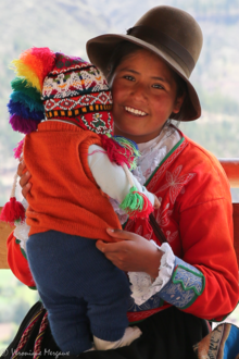 Amerindian girl holding her little brother.png