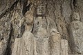 Ancient Buddhist Grottoes at Longmen- Three Buddhas on the Cliff, Seated Buddha in the Middle.jpg