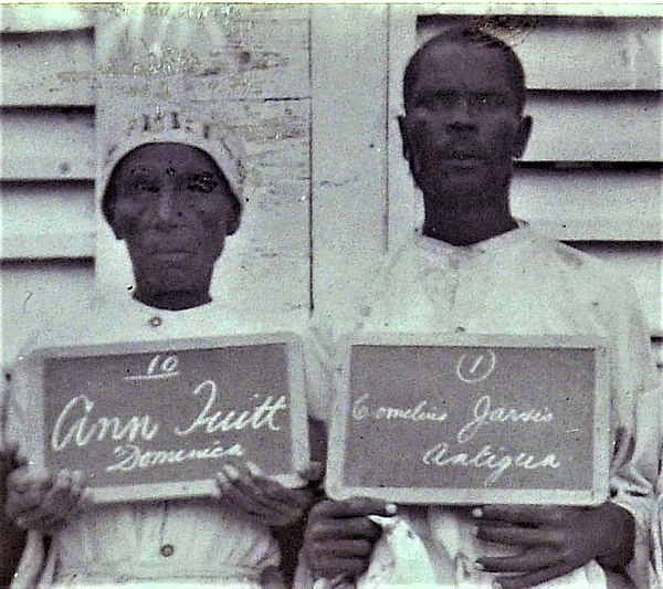 Two imprisoned Obeah practitioners in Antigua, part of a group photographed in 1905.