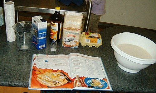 A recipe in a cookbook for pancakes with the prepared ingredients