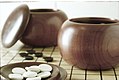 Image 4An example of single-convex stones and Go Seigen bowls. These particular stones are made of Yunzi material, and the bowls of jujube wood. (from Go (game))
