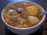 Caldo de res is a Mexican dish made with corn, green beans, potatoes, carrots, potatoes, cabbage and cilantro.