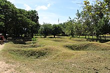 Mass graves at the Killing Fields of Choeung Ek in Cambodia. Cambodia 2011 monuments 20.jpg