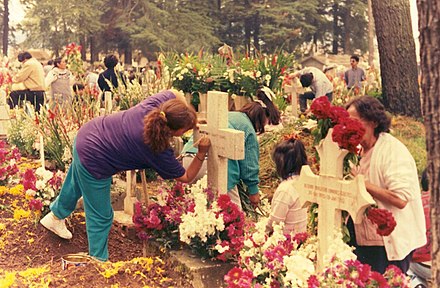 Families tidying and decorating graves at a cemetery in Almoloya del Río in the State of Mexico, 1995