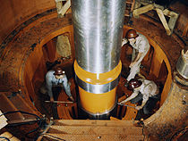 Workers test a turbine shaft at Watts Bar, June 1942 Checking the alignment of a turbine shaft at the top of the guide bearing in TVA's hydroelectric plant, Watts Bar Dam, Tenn.jpg