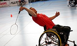A para-badminton player playing on wheelchair