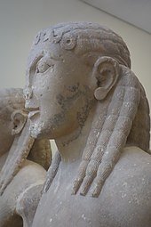 It is thought the ancient Greek Kouros statues wore dreadlocks. However, historians and archeologists who specialize in ancient Greek hairstyles suggest they were not dreadlocks but braids. For example, academics at Reed College explained that they were braids of thick, dense hair braided together "divided into uniform globules." "During the archaic period (i.e., up to about 500 BC) the male youth or kouros (Greek) wore his hair long to the shoulders or even longer finely braided--an extremely artificial time-consuming style of the privileged nobles." Janet Stephens explains some of the Kouros statues had curly hair. Delfimuseum 05.JPG