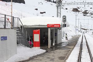 Snow-covered single-story building on a platform