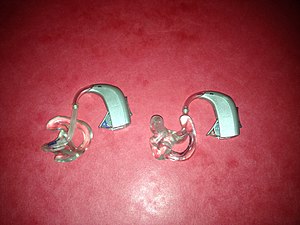 A pair of Oticon Spirit Zest digital BTE (Behind the Ear) hearing aids.