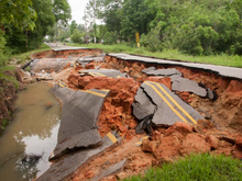 Flooding of a small stream in June 2014 destroyed this roadbed in Foley, Alabama. Foley2014flood.png