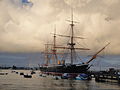 HMS Warrior, in Portsmouth, Hampshire, seen just after sunrise, with the morning sun still reflected in the clouds.