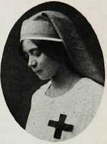 Seorang wanita muda yang mengenakan Palang Merah seragam perawat, dari tahun 1918.