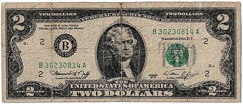 A series 1976 $2 bill, heavily yellowed and worn from over four decades of circulation and use.