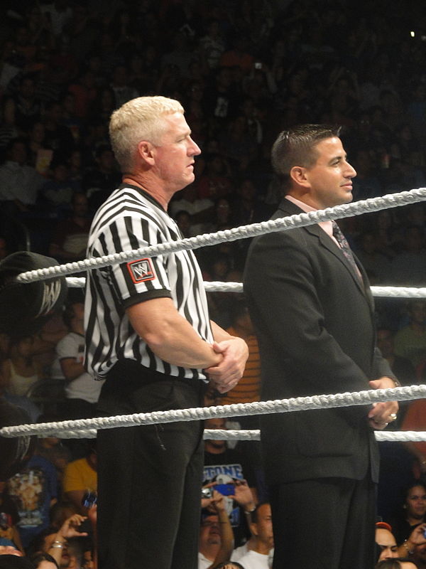 Armstrong (left) in the ring with Justin Roberts