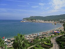 Kemer Beach in Antalya on the Turkish Riviera (Turquoise Coast). In 2019, Turkey ranked sixth in the world in terms of the number of international tourist arrivals, with 51.2 million foreign tourists visiting the country. Kemer beach, Antalya.jpg