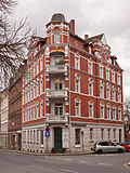 Apartment building, freestanding to the right, corner house