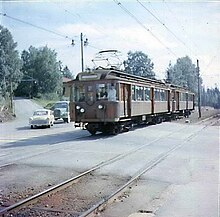 Train crossing Sørkedalsveien ahead of an Opel Kapitän in 1958