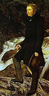 John Ruskin wears a dark frock coat over lighter trousers and low-heeled shoes. He carries a soft-crowned brown hat. Detail of a portrait by John Everett Millais, 1853-54. Millais Ruskin Detail.jpg