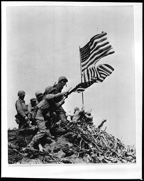 Marine Corps photo of the two flags on Mount Suribachi (Pfc. Gagnon in forefront helping to lower the first flag)