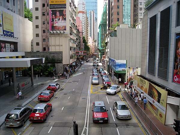 Looking west, next to the entrance of Hopewell Centre (left). No. 183.