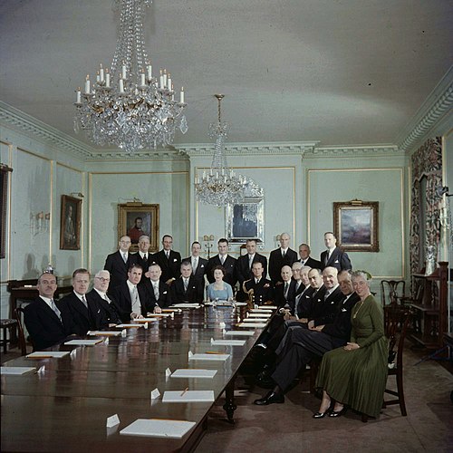 The first meeting of the Privy Council before the reigning sovereign; in the State Dining Room of Rideau Hall. Queen Elizabeth II is seated at centre,