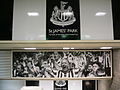 Many panels in the station feature images of the adjacent St James' Park football stadium or former Newcastle United F.C. players. This is the view from one of the escalators.