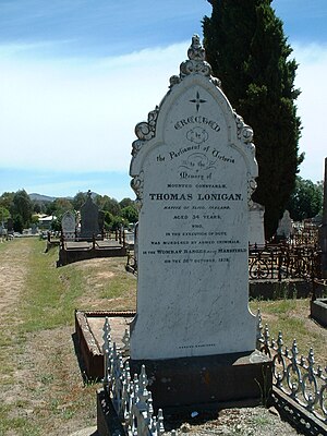 Large white headstone with the details of Lonigan's death