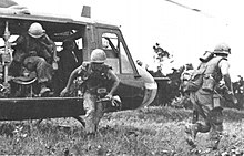 Troops dismounting a UH-1 during the Vietnam War. Troops leaving UH-1 copter.jpg