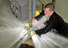 US Navy 040308-N-0000P-002 Sailors practice repairing leaks in the "wet trainer" on board the Submarine Training Facility (SUBTRAFAC) in Norfolk, Va.jpg