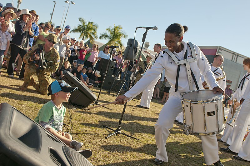 File:US Navy 110709-N-CZ945-703 Musician 3rd Class Camellia Akhami interacts with a boy during the opening ceremony performance for Talisman Sabre 2011.jpg