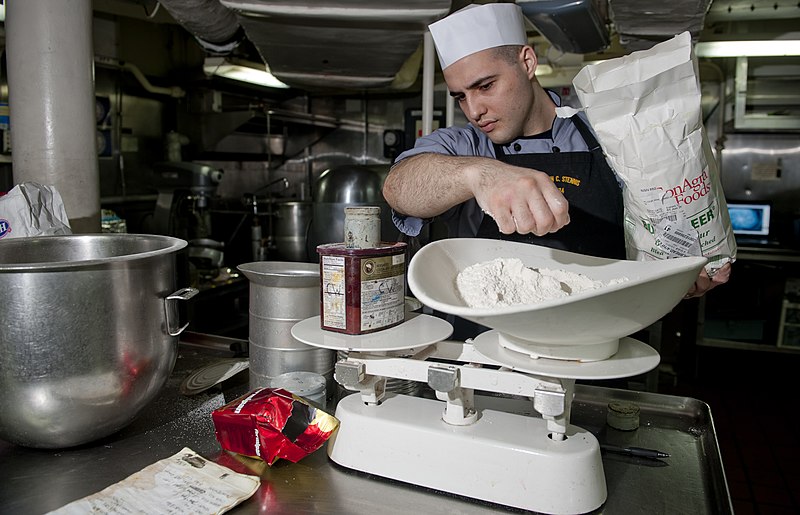 File:US Navy 111220-N-OY799-007 Culinary Specialist Seaman Matthew Ryback measures flour in preparation for the Christmas meal in the bake shop aboard t.jpg