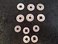 Silver coins with circle, triangle, square or diamond holes