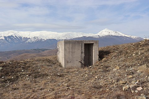 An abandoned shelter with Šar Mountains in the background