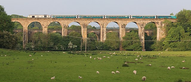 Train on the Chirk Viaduct, with the Chirk Aqueduct in the background, near Chirk, Wrexham on the Wales–England border.