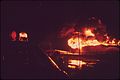 A TEXACO CRUDE OIL TANK BLAZES AGAINST THE NIGHT AFTER BEING STRUCK BY LIGHTNING - NARA - 543900.jpg