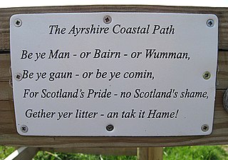 Sign reading "The Ayrshire Coastal Path/Be ye man or Bairn or Wumman,/Be ye gaun or be ye comin,/For Scotland's Pride – no Scotland's shame,/Gather yer litter – an tak it Hame!"